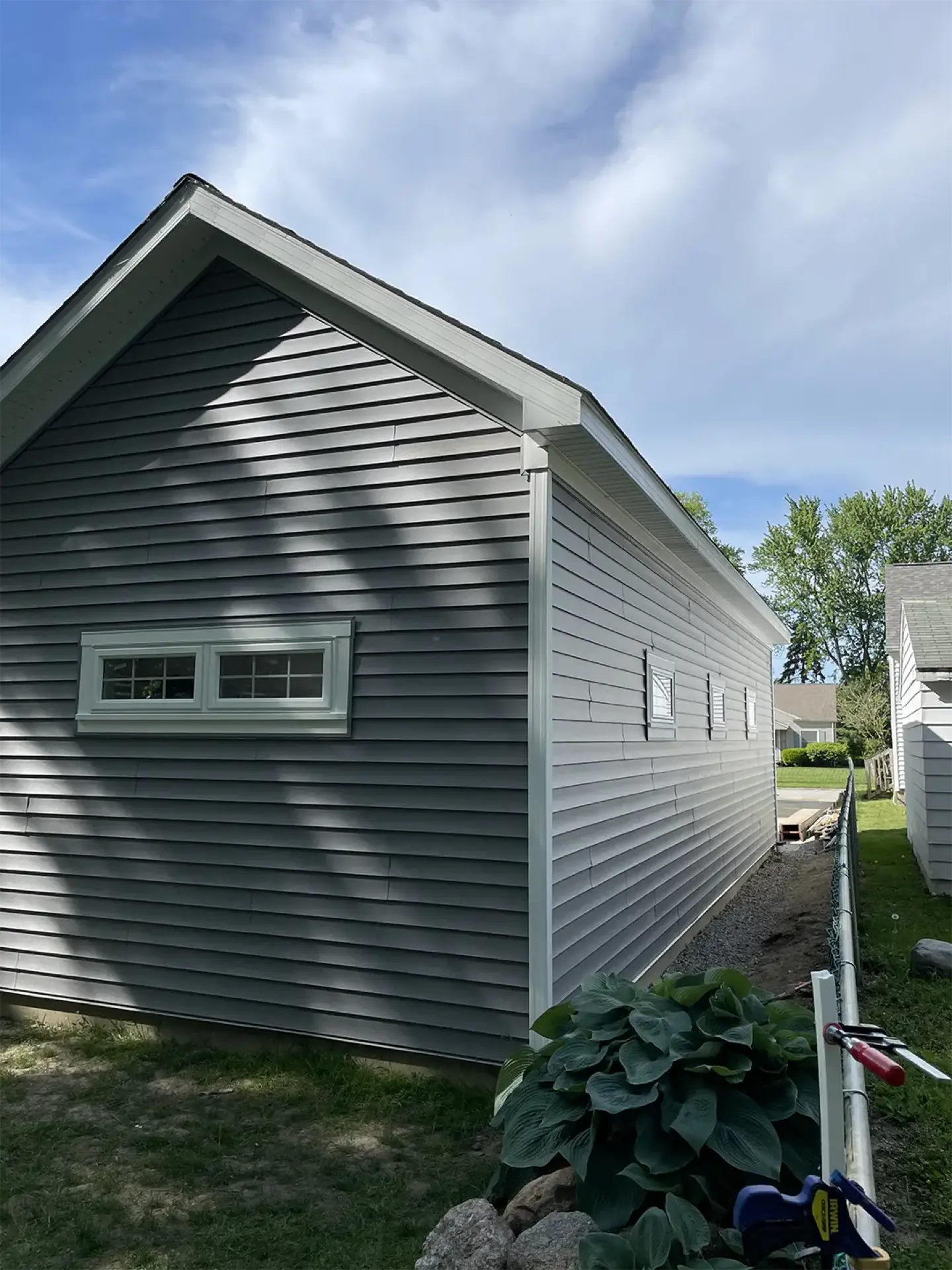 Garage side view with gray siding
